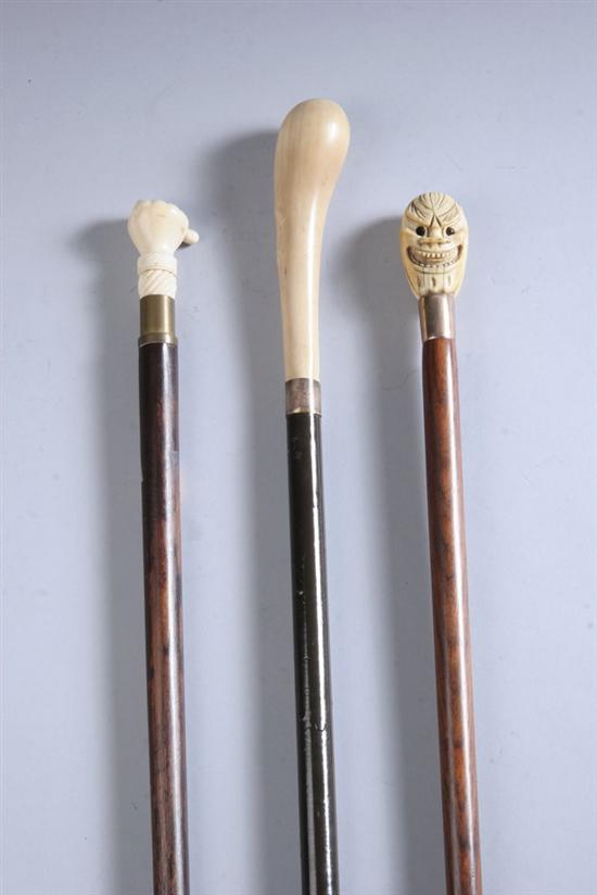 Appraisal: THREE IVORY HANDLED CANES One with two opposing grotesque faces