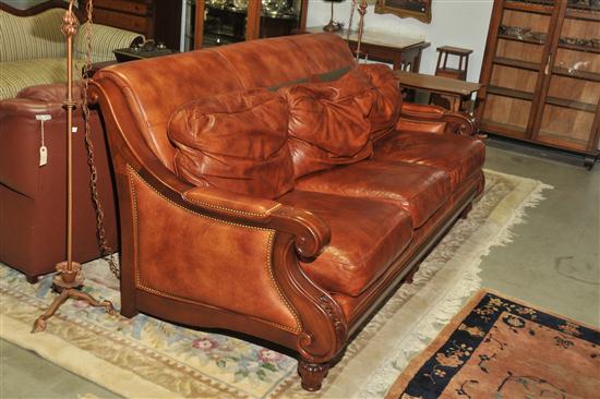 Appraisal: HANCOCK MOORE LEATHER SOFA Mahogany frame with carved accents and