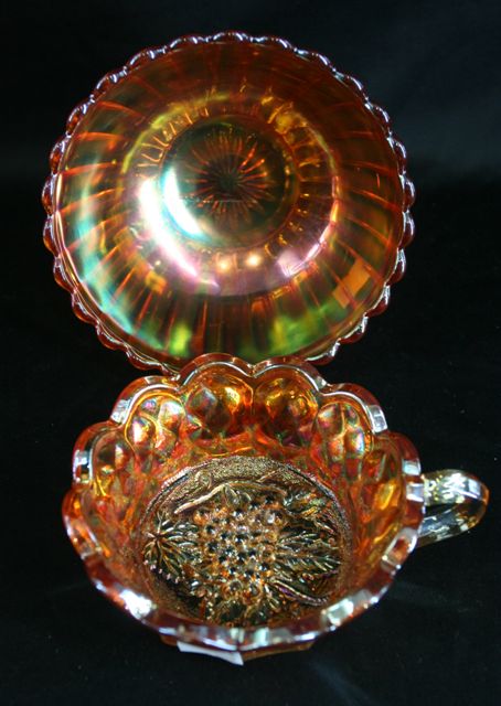 Appraisal: A carnival glass grape vine cup together with a fluted