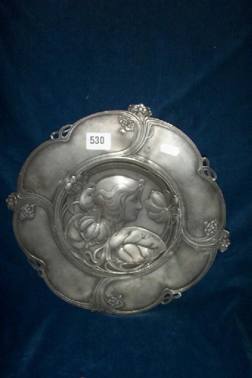 Appraisal: A WMF pewter charger with relief decoration of a young