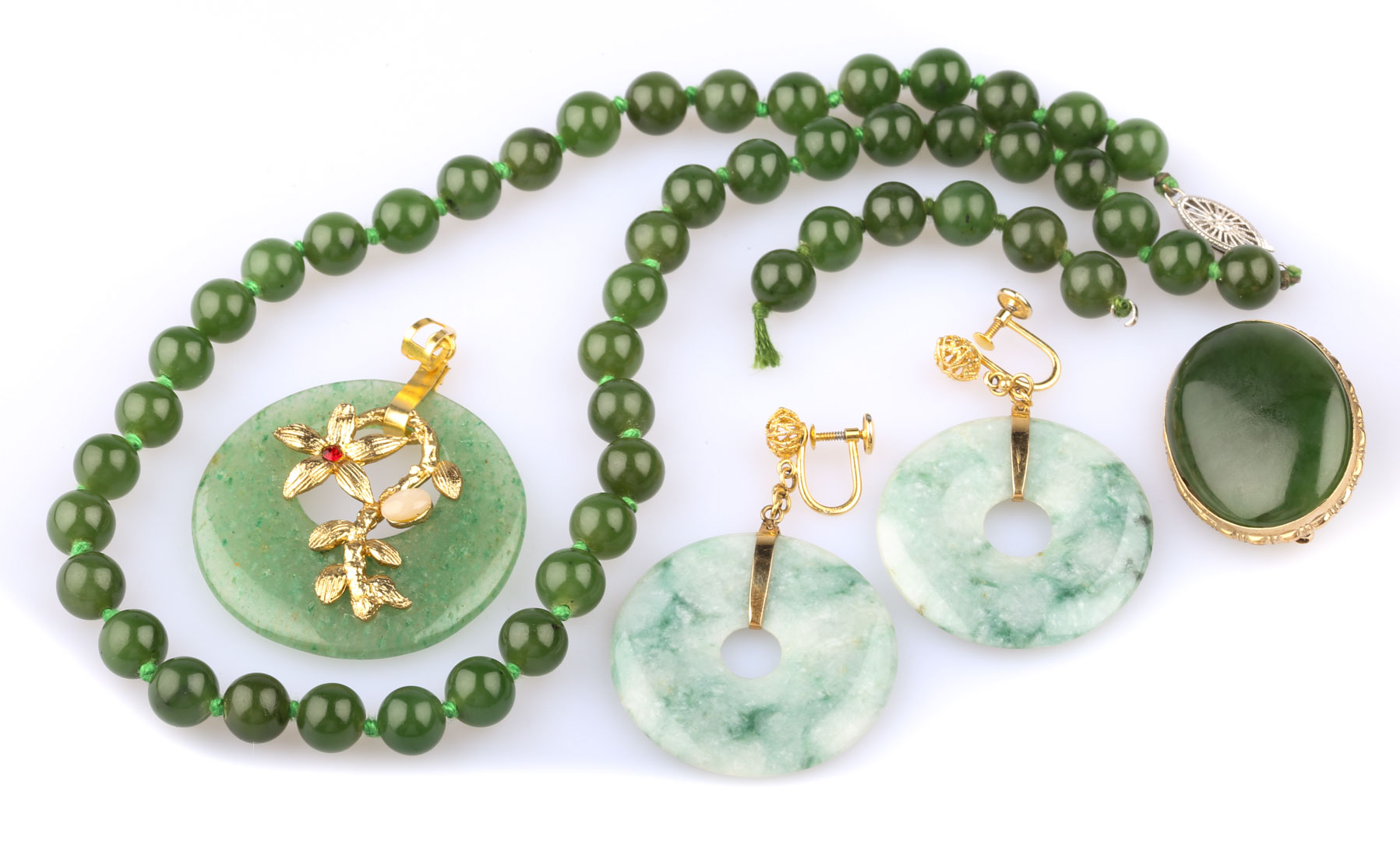 Appraisal: A Selection of Jade Jewelry Featuring a K round pendant