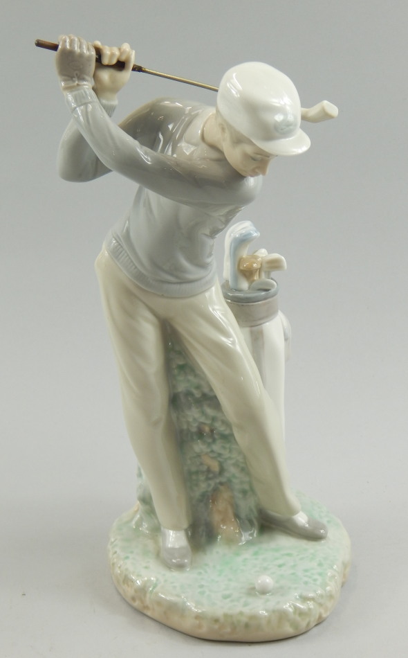 Appraisal: A Lladro porcelain figure modelled with a golfer taking a