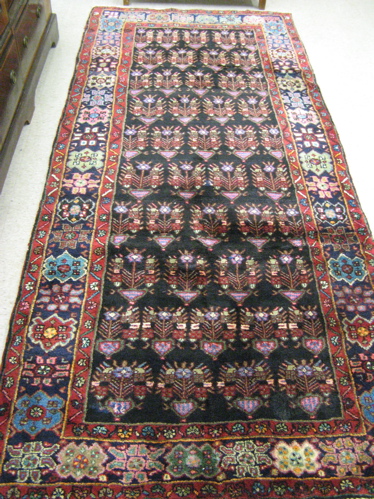 Appraisal: PERSIAN KURDISH AREA RUG the black field filled with repeating