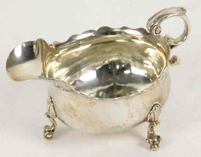 Appraisal: A George II silver sauceboat marks rubbed with wavy rim