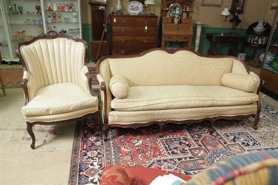 Appraisal: SOFA AND ARMCHAIR Both walnut with carved accents sofa has