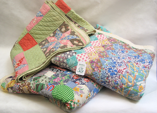 Appraisal: THREE AMERICAN PATCHWORK QUILTS hand stitched in pastel colors reverse