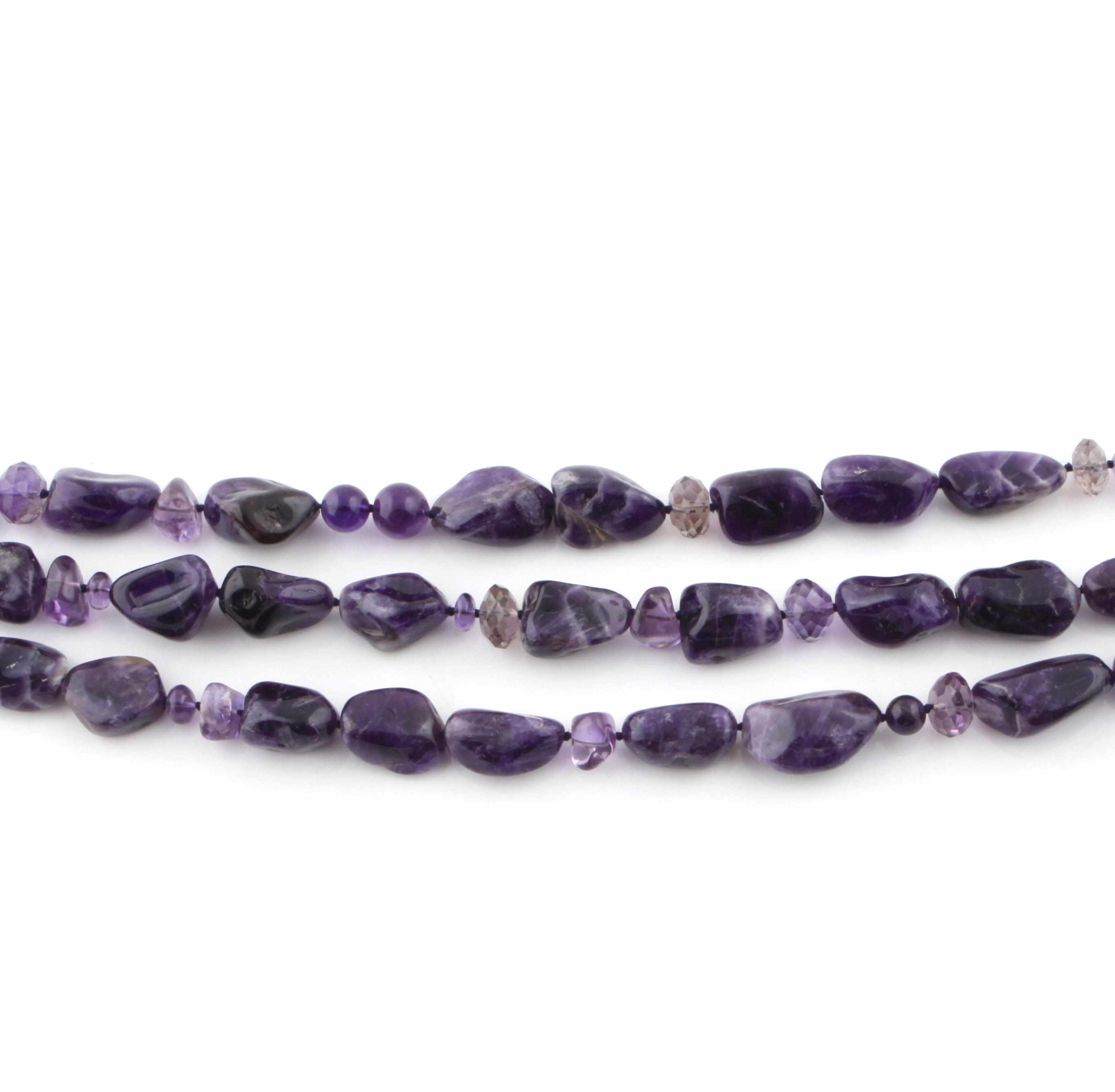 Appraisal: An amethyst bead and metal row necklace length approximately in