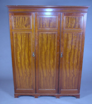 Appraisal: A mahogany triple wardrobe circa the cornice above three doors