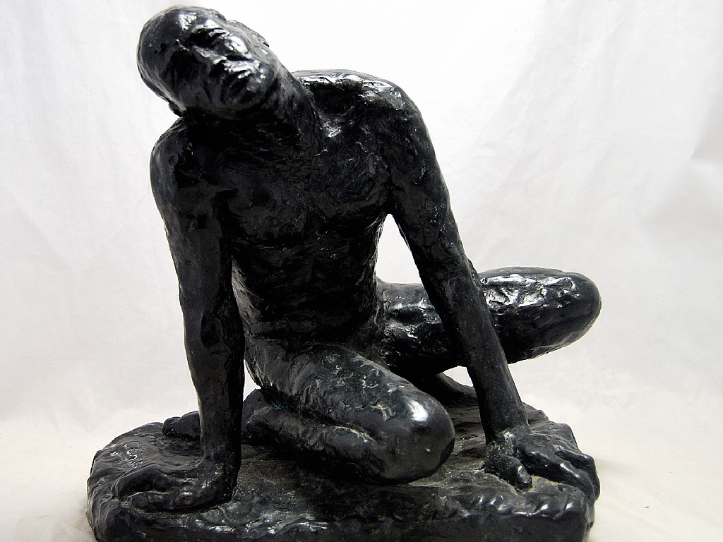 Appraisal: A patinated bronze of a kneeling male figure indistinctly signed