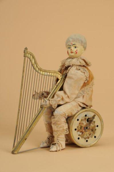 Appraisal: Clown Musician with Harp Germany ca musical plink plunk mechanism