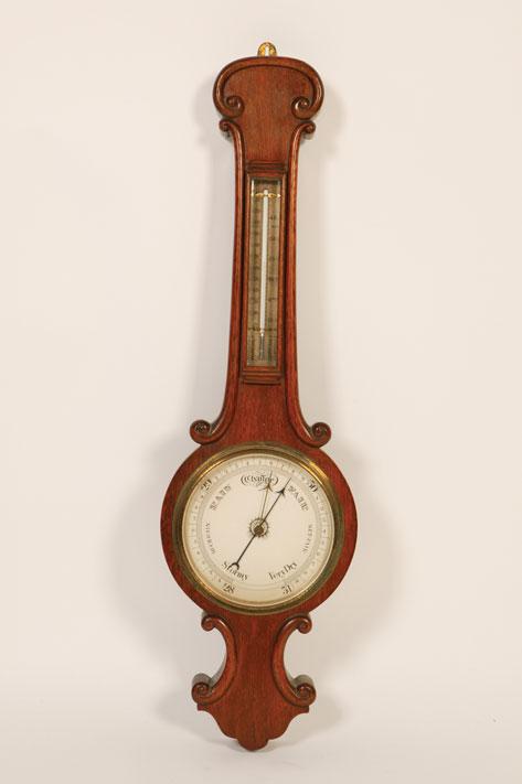 Appraisal: A VICTORIAN OAK FRAMED BANJO BAROMETER with a mercury filled