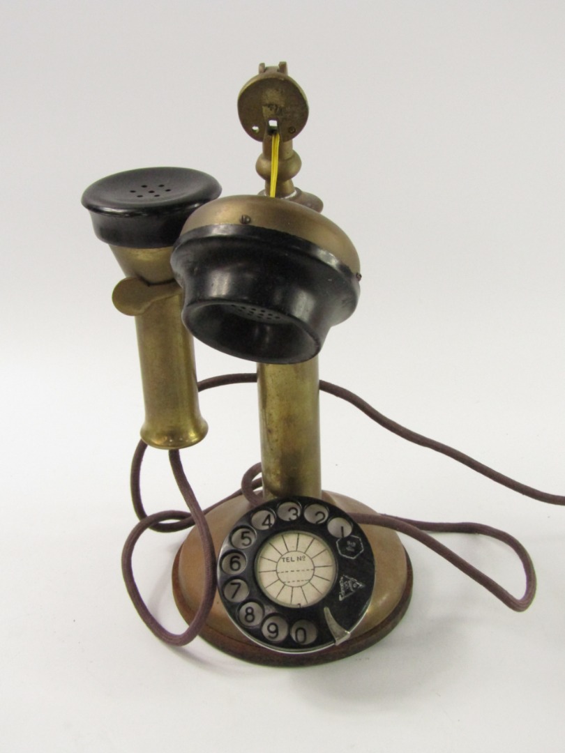 Appraisal: A brass and bakelite candlestick telephone cm high