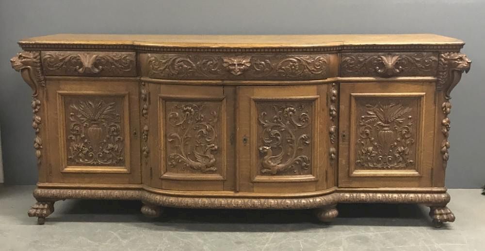 Appraisal: Oak Sideboard with Carved Lion Heads Griffins Oak sideboard circa