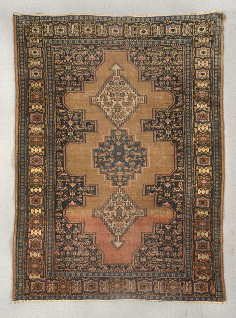 Appraisal: A KURDISH BROWN GROUND RUG with a central interlinked medallion