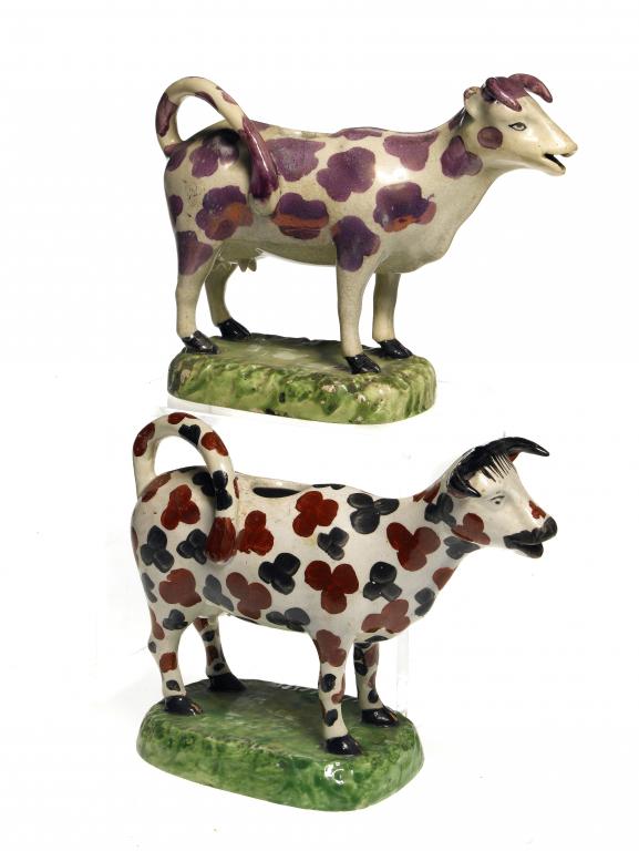 Appraisal: TWO PEARLWARE COW CREAMERS one sponged in black and red