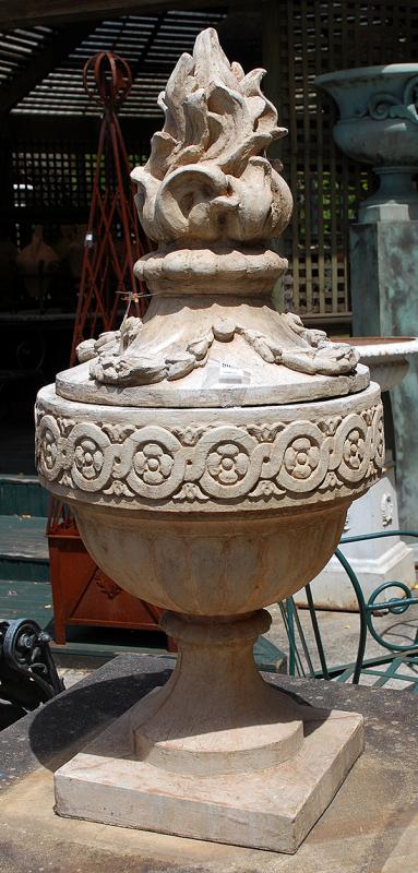 Appraisal: A PAIR OF COMPOSITE STONE URNS WITH FLAME FINIALSthe top