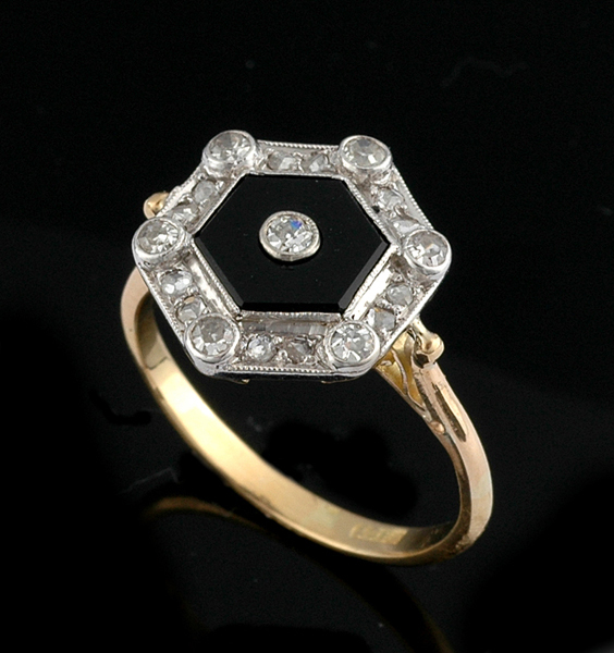 Appraisal: AN ONYX AND DIAMOND PLAQUE RING The hexagonal onyx plaque