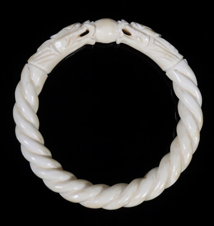 Appraisal: Carved ivory bangle bracelet with overall twist ending in two