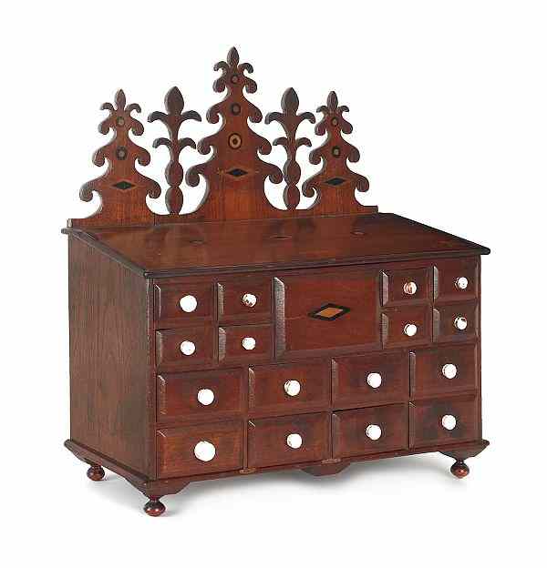 Appraisal: Pennsylvania walnut spice cabinet ca with an elaborately carved crest