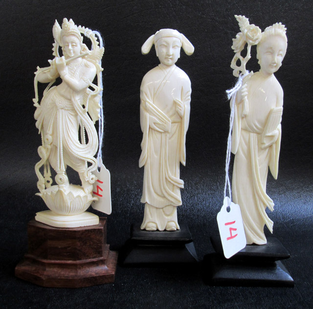 Appraisal: THREE IVORY CARVED FIGURES standing on wood plinth bases Figures