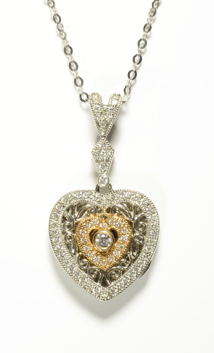 Appraisal: DIAMOND AND EIGHTEEN KARAT GOLD HEART LOCKET PENDANT NECKLACE the