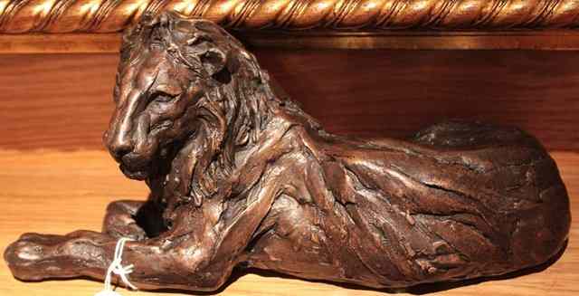 Appraisal: A CONTEMPORARY BRONZE SCULPTURE of a resting lion indistinctly signed