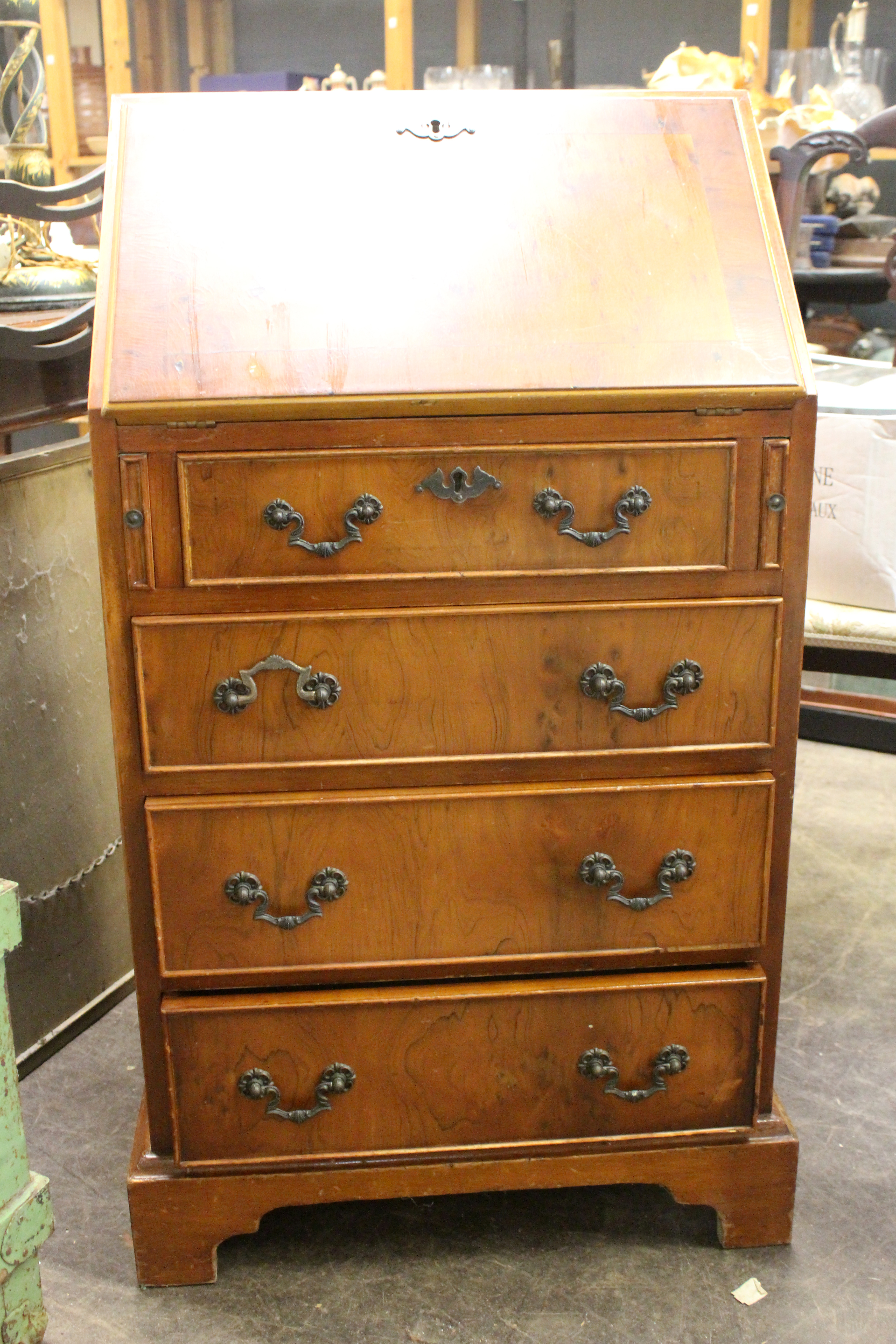 Appraisal: A lady's reproduction yewwood bureau with four drawers below cm