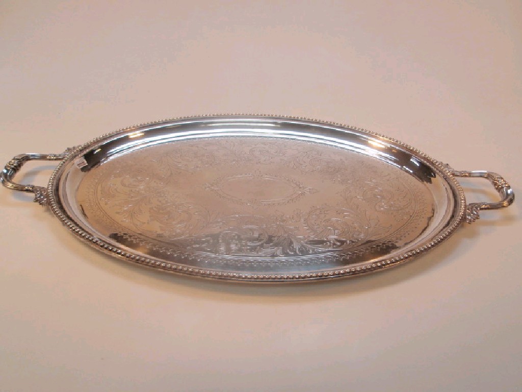 Appraisal: An early thC electroplated oval tea tray with scroll handles