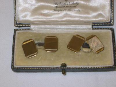 Appraisal: A PAIR OF CT GOLD CUFF LINKS comprising engine turned