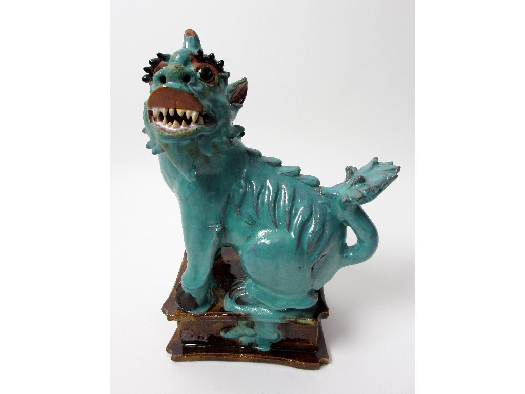 Appraisal: A Chinese turquoise glazed pottery dog of fo on moulded