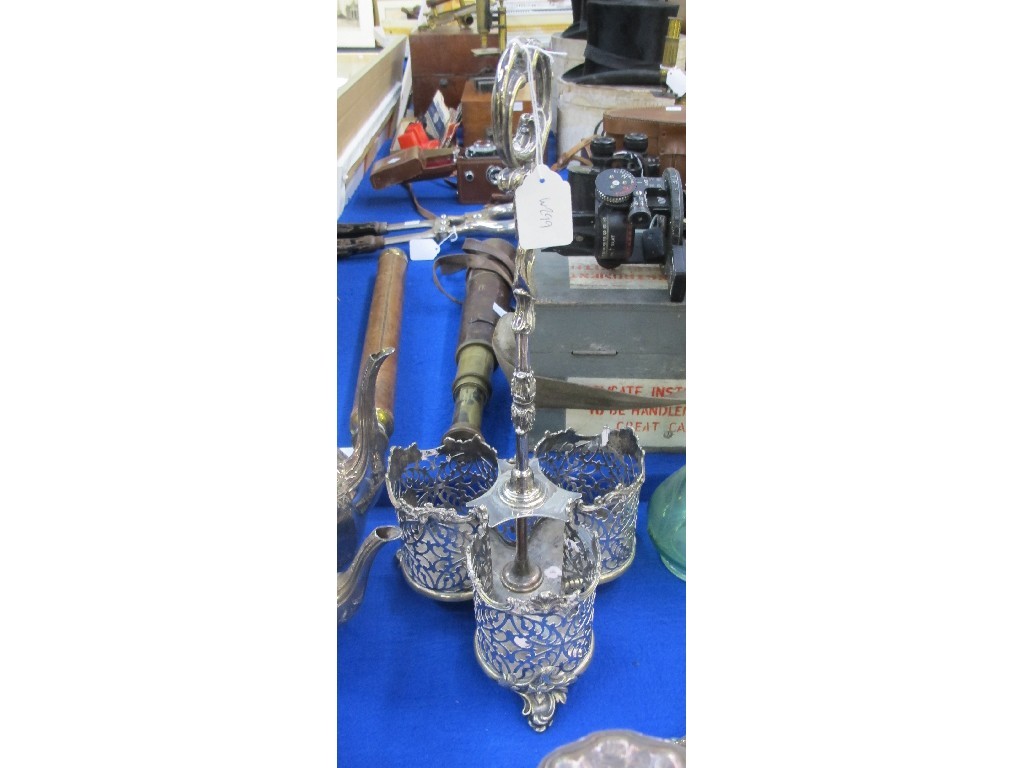 Appraisal: A silver plated three-bottle decanter stand