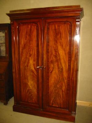 Appraisal: A VICTORIAN MAHOGANY DOUBLE WARDROBE with moulded cornice and plain