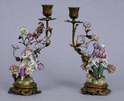 Appraisal: PAIR OF LOUIS XV-STYLE PORCELAIN-MOUNTED GILT-METAL CANDLESTICKS Each centered by