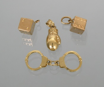 Appraisal: A Whimsical Group of Gold Charms Containing a boxing glove