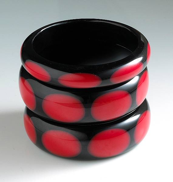 Appraisal: A collection of three bakelite dot bangle bracelets all of