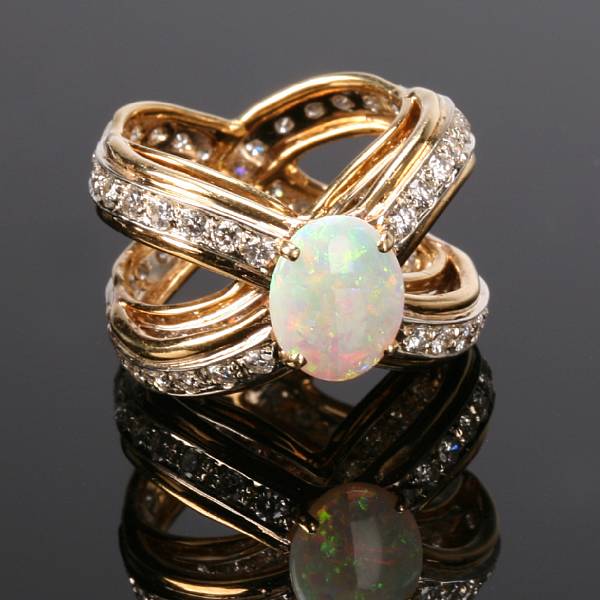 Appraisal: An opal diamond and eighteen karat yellow gold ring the