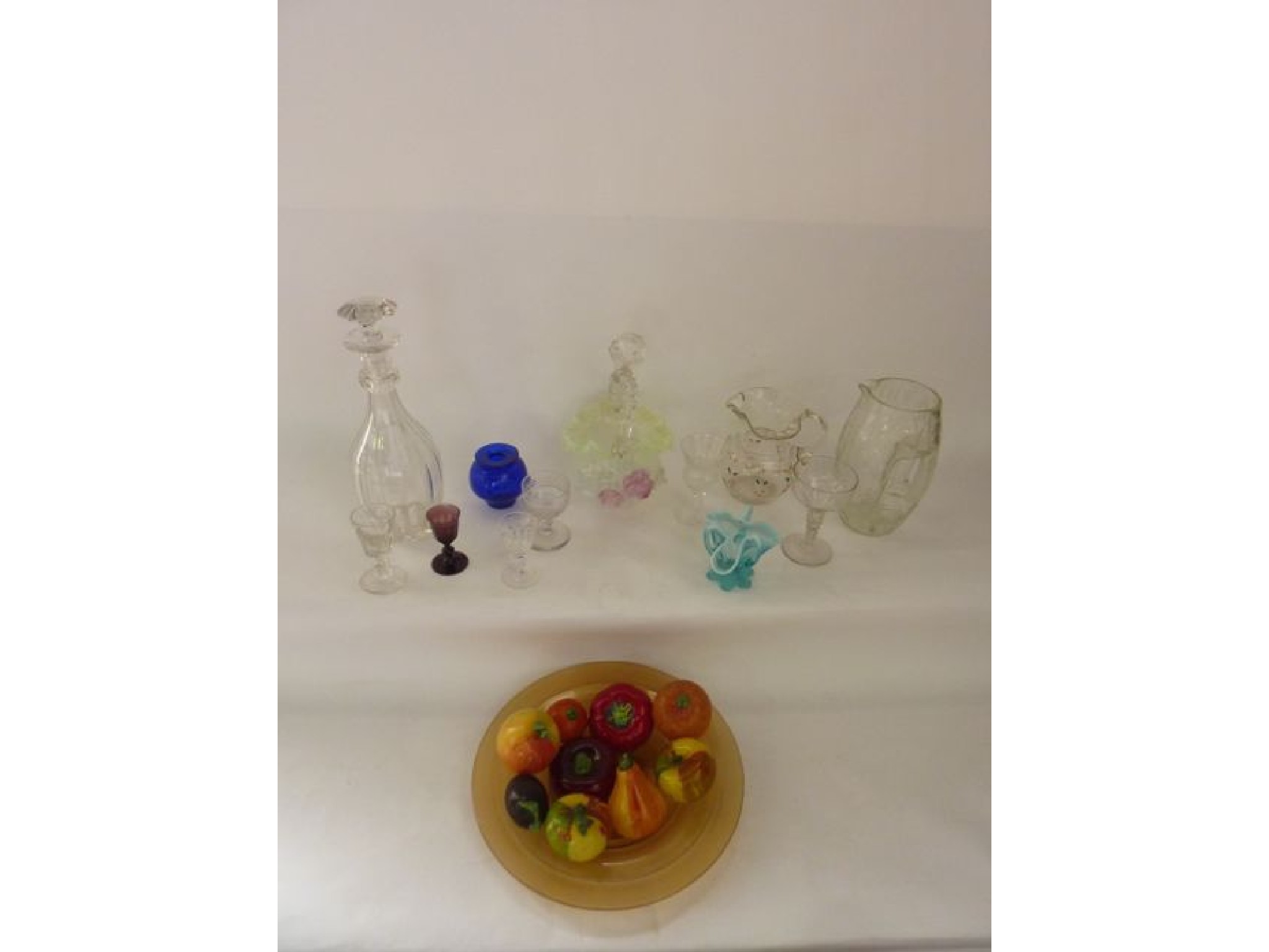 Appraisal: A selection of brightly coloured glass models of fruit with