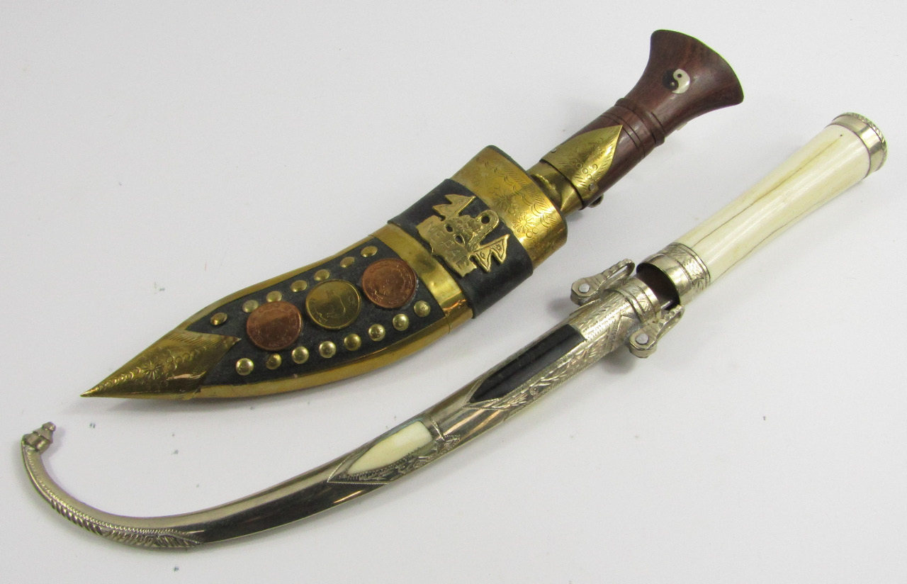 Appraisal: A Nepalese Kukri with wooden handle and leather sheath overlaid