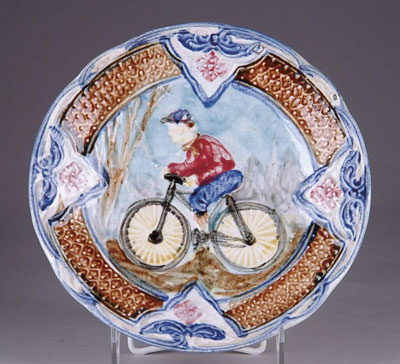 Appraisal: GREAT OLD MAJOLICA BICYCLE PLATE This antique majolica plate features