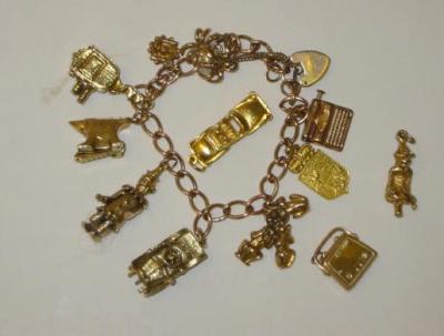 Appraisal: A CT GOLD CHARM BRACELET wide curb links hanging with