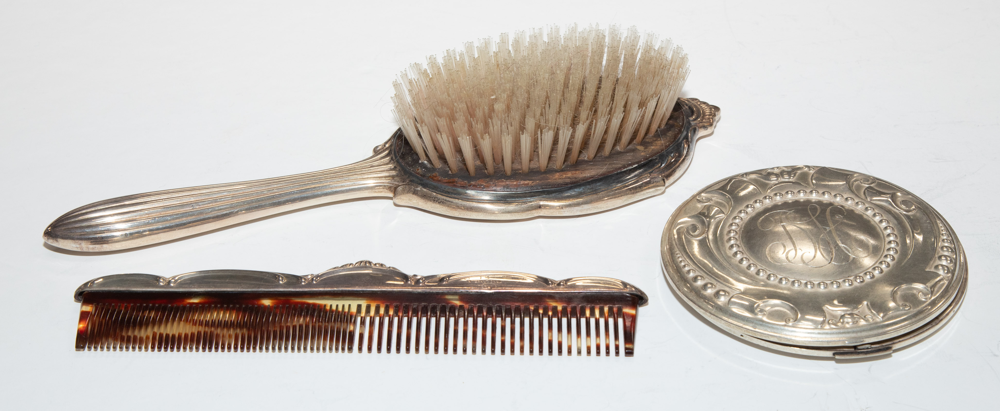 Appraisal: THREE STERLING-MOUNTED DRESSER ITEMS Including International hairbrush and comb and