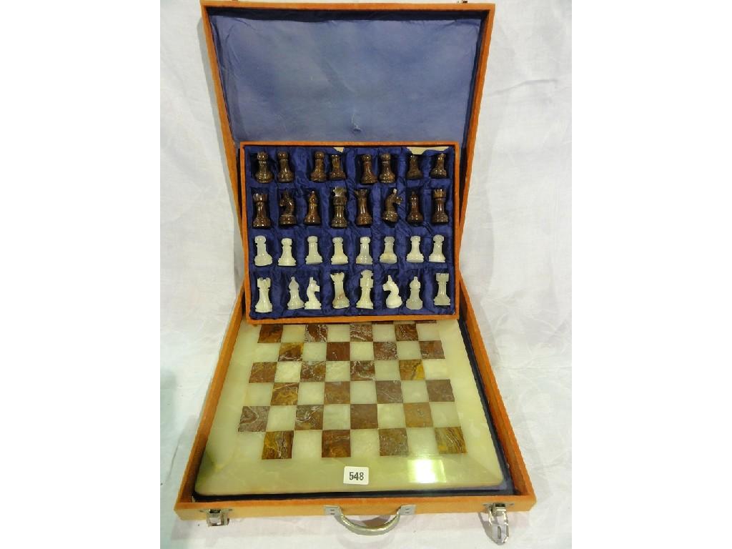 Appraisal: A chess set with marble checkerboard and marble chess pieces