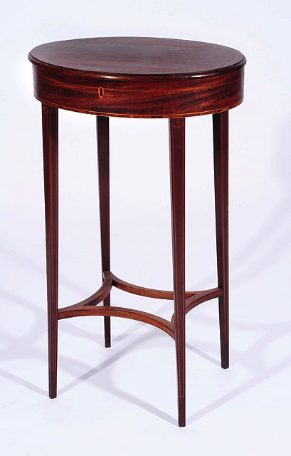 Appraisal: A TH CENTURY MAHOGANY OVAL WORK TABLE with sliding top