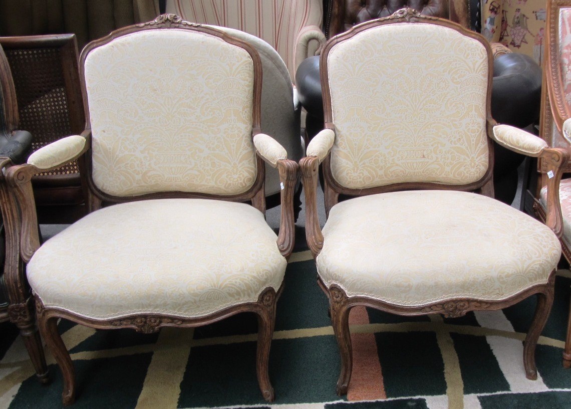 Appraisal: A pair of th century French carved fauteuils in the