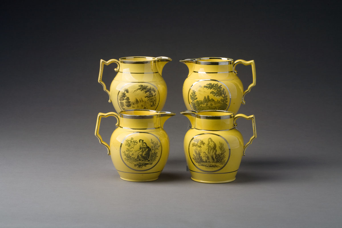 Appraisal: FOUR ENGLISH YELLOW-GLAZED SILVER LUSTRE AND BLACK TRANSFER-PRINTED JUGS CIRCA