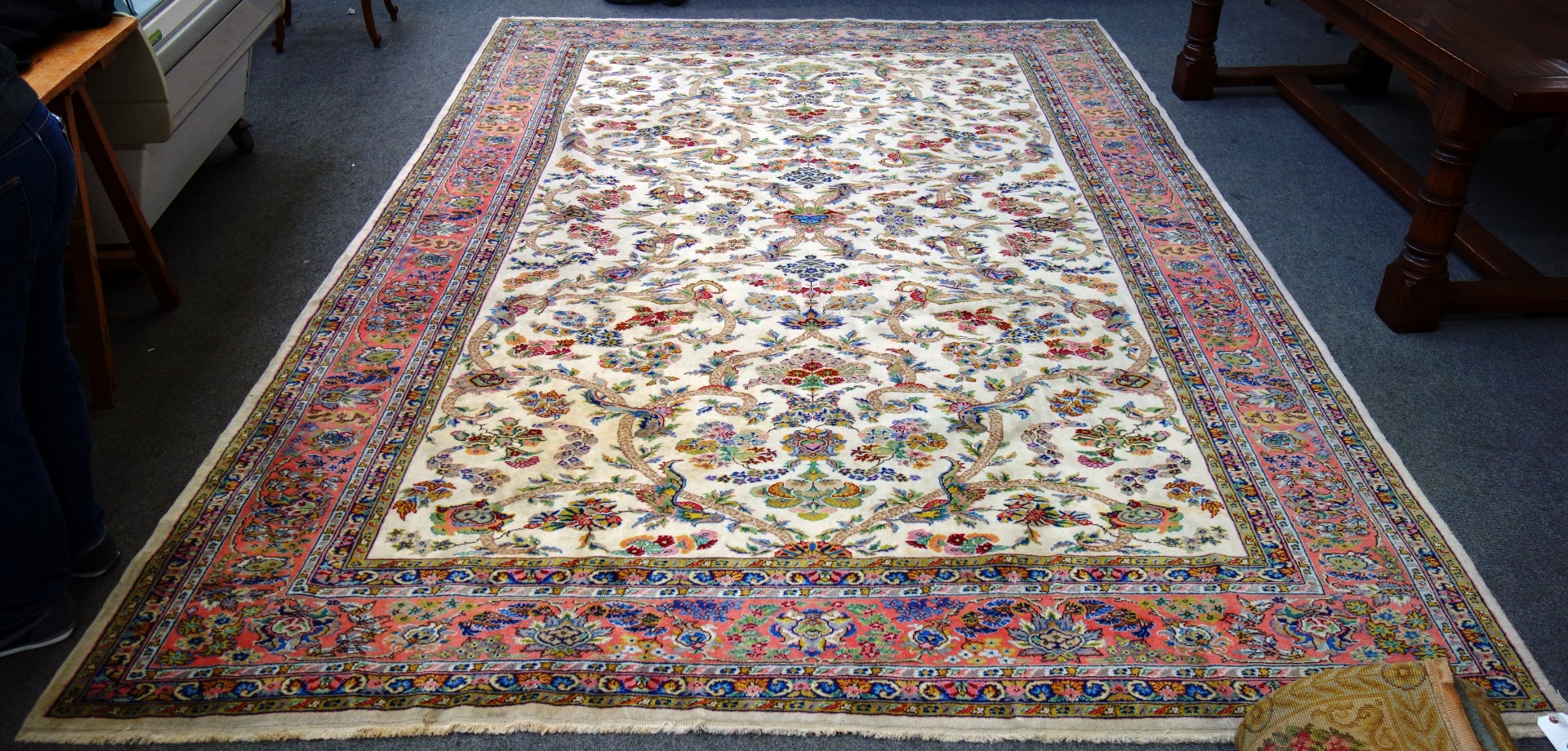 Appraisal: A Turkish carpet the ivory field with a trailing vine