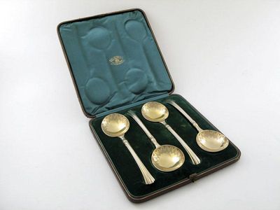 Appraisal: A set of four Victorian silver-gilt fruit spoons fluted stems