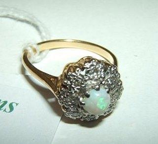 Appraisal: An opal and diamond set dress ring the claw set