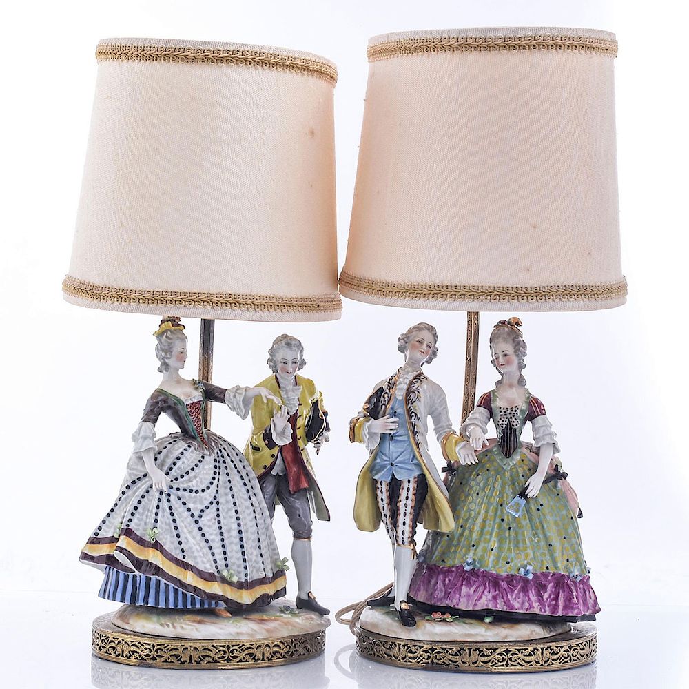 Appraisal: CONTINENTAL PORCELAIN FIGURAL ELECTRICAL LAMPS Reticulated base brass hand painted