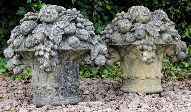 Appraisal: A PAIR OF CAST COMPOSITE STONE BASKETS OF FRUIT GARDEN